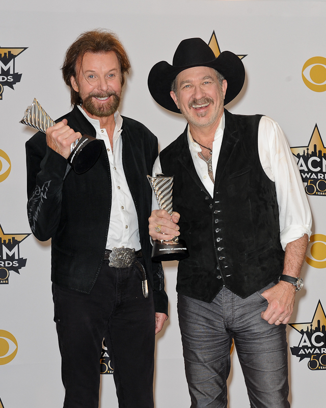 Musicians Ronnie Dunn (L) and Kix Brooks of Brooks & Dunn, recipients of the Milestone Award for Most Awarded Artist pose in the press room at the 50th Academy Of Country Music Awards at AT&T Stadium on April 19, 2015 in Arlington, Texas. Photo © Manuel Nauta
