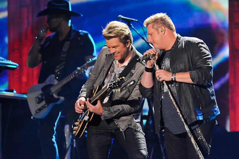 Musicians J.D. Rooney and Gary LeVox of Rascal Flatts perform onstage during the 2015 iHeartRadio Country Festival at The Frank Erwin Center on May 2, 2015 in Austin, Texas. 